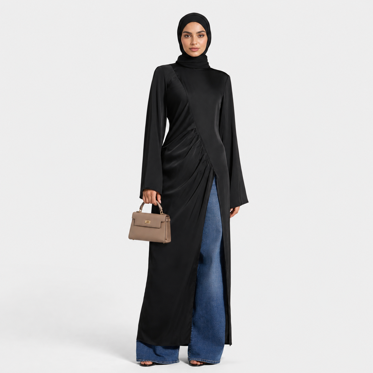 Woman wearing a black dress with a brown handbag on a white background
