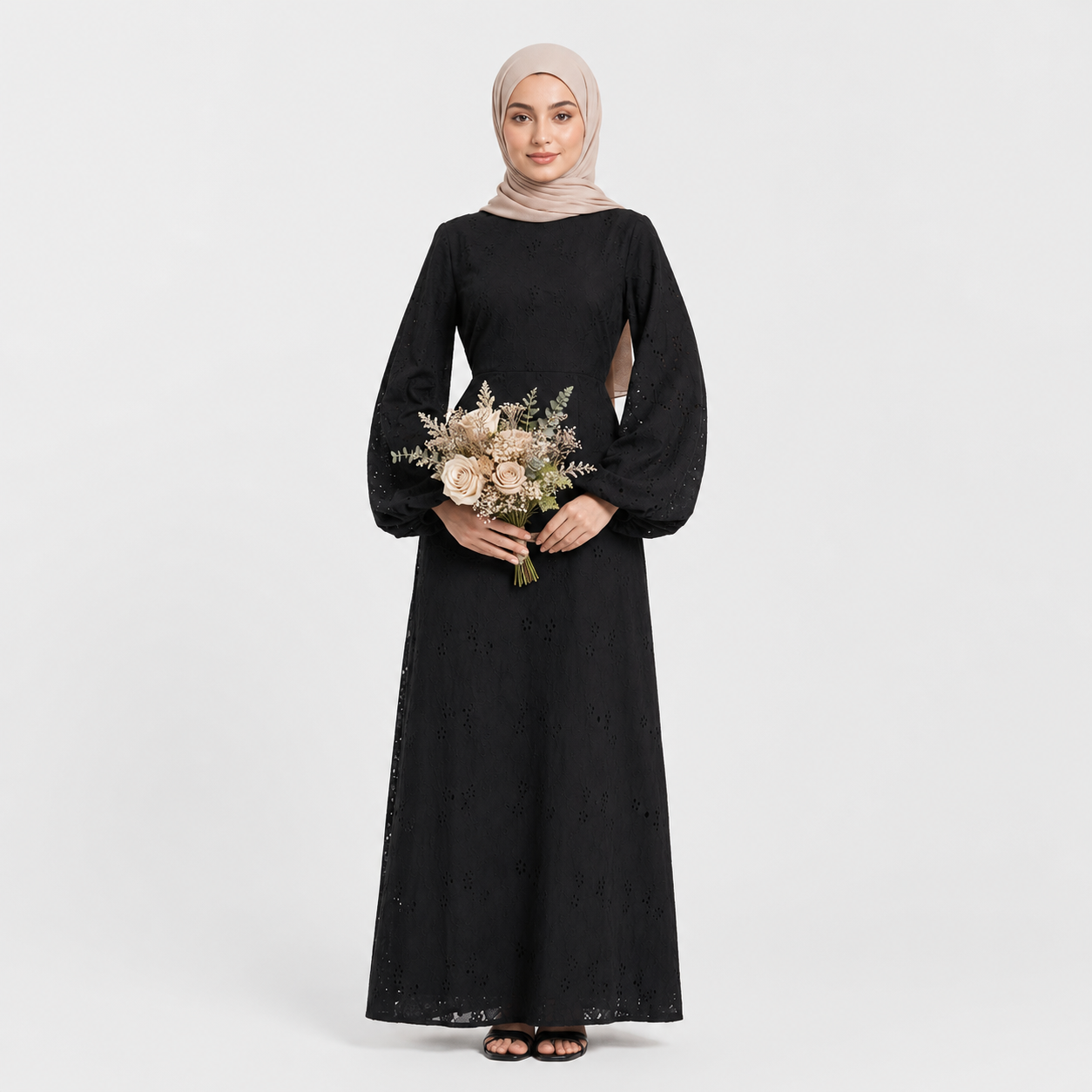 Woman wearing a black dress holding flowers on a white background