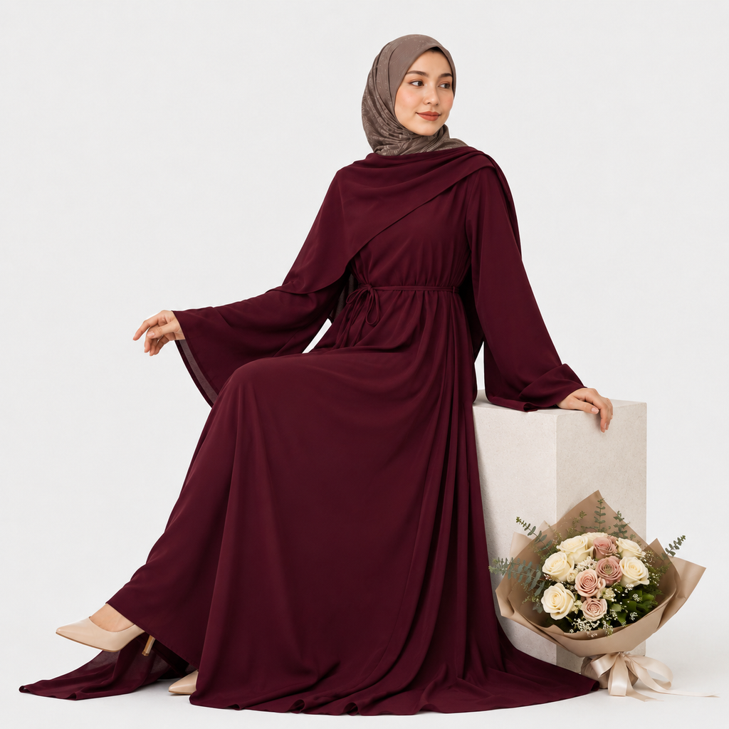 Woman in a burgundy dress with a hijab holding a bouquet of flowers on a white background