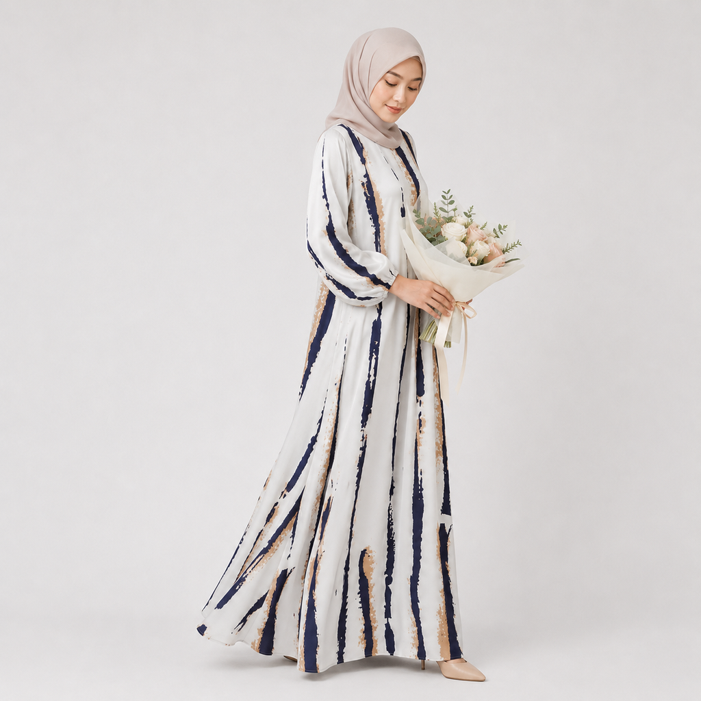 Woman in a long, patterned dress holding flowers against a plain background