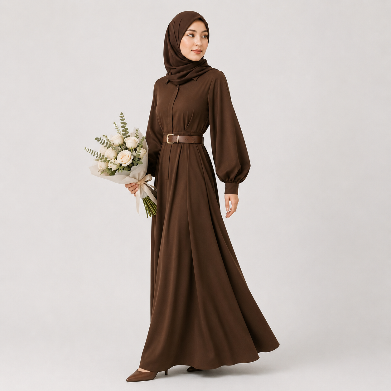 Woman wearing a brown dress and hijab holding flowers on a white background