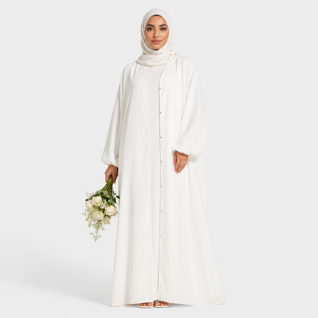 Woman in a long, light-colored dress holding flowers on a white background