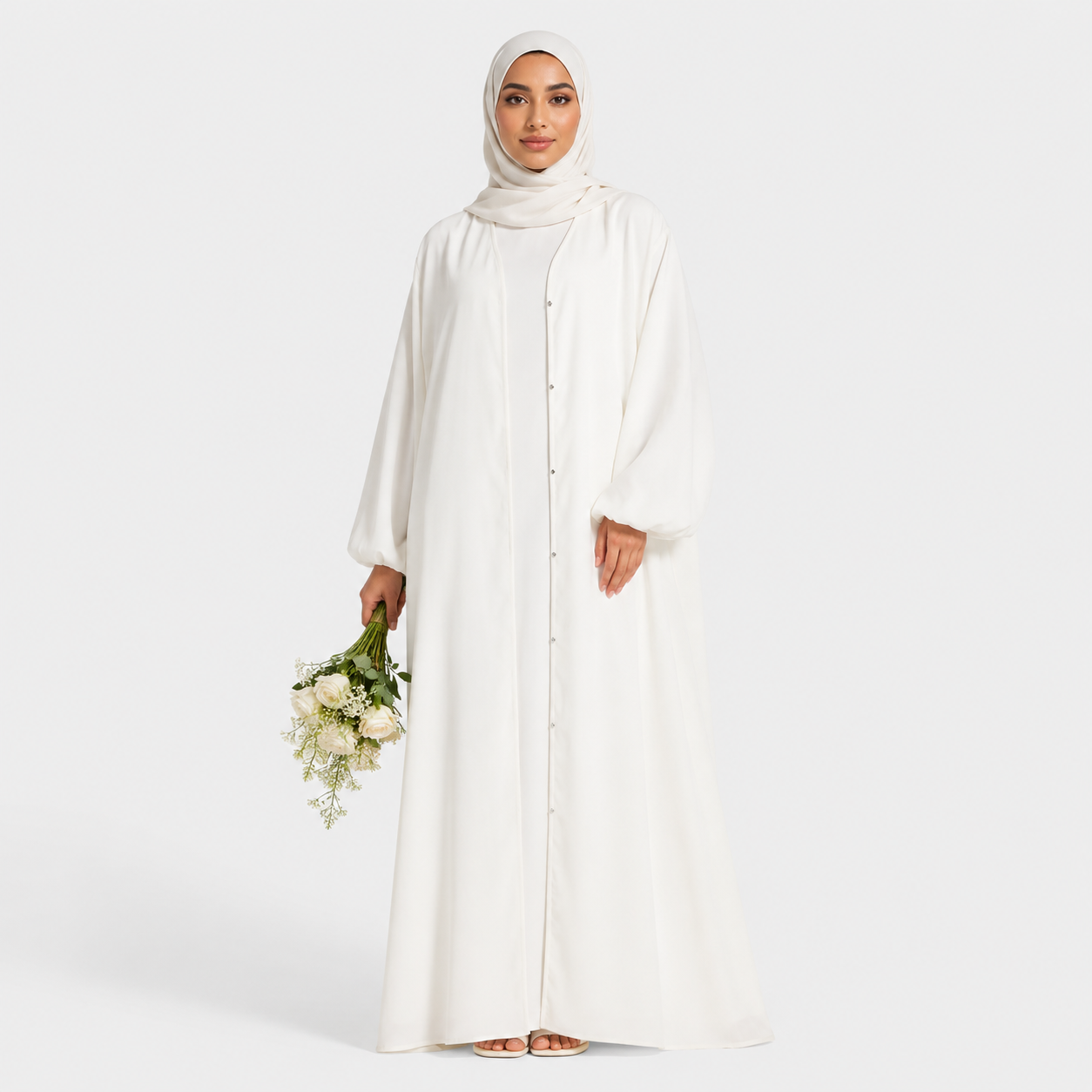 Woman in a long, light-colored dress holding flowers on a white background