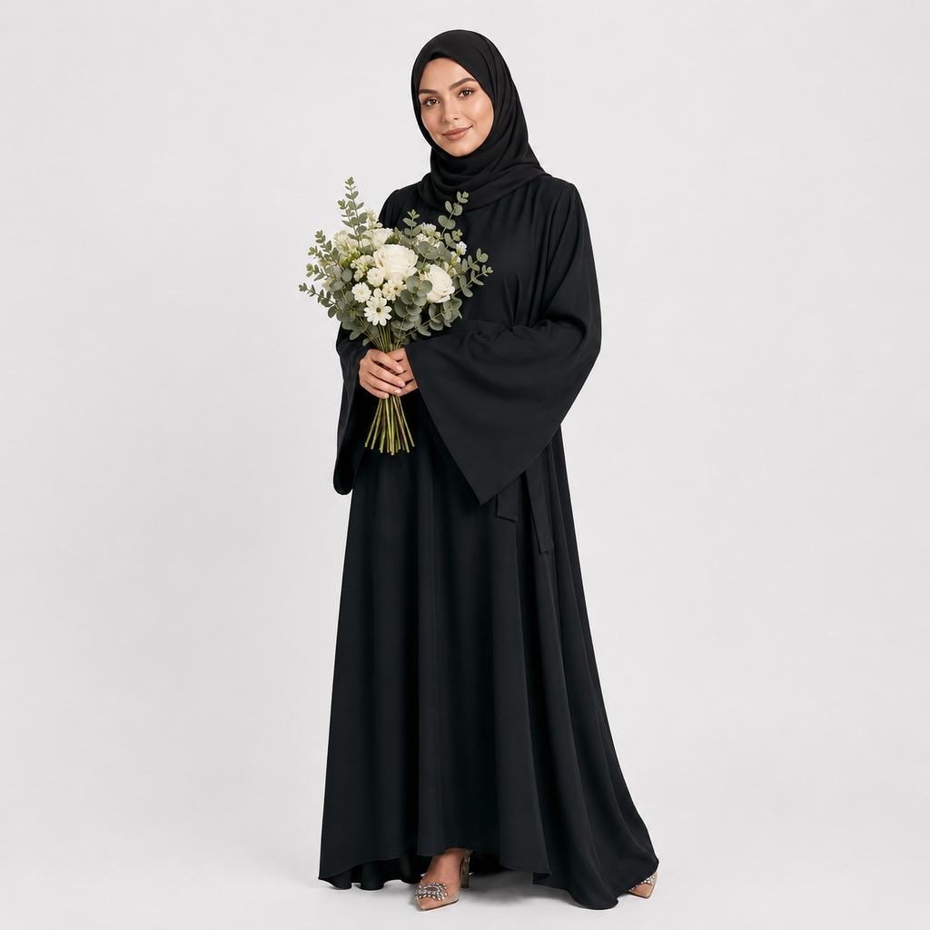 Woman in a black abaya holding a bouquet of flowers on a white background