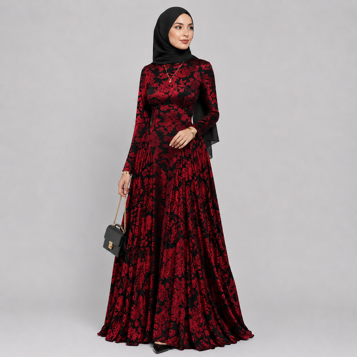 Woman wearing a red and black floral dress on a gray background