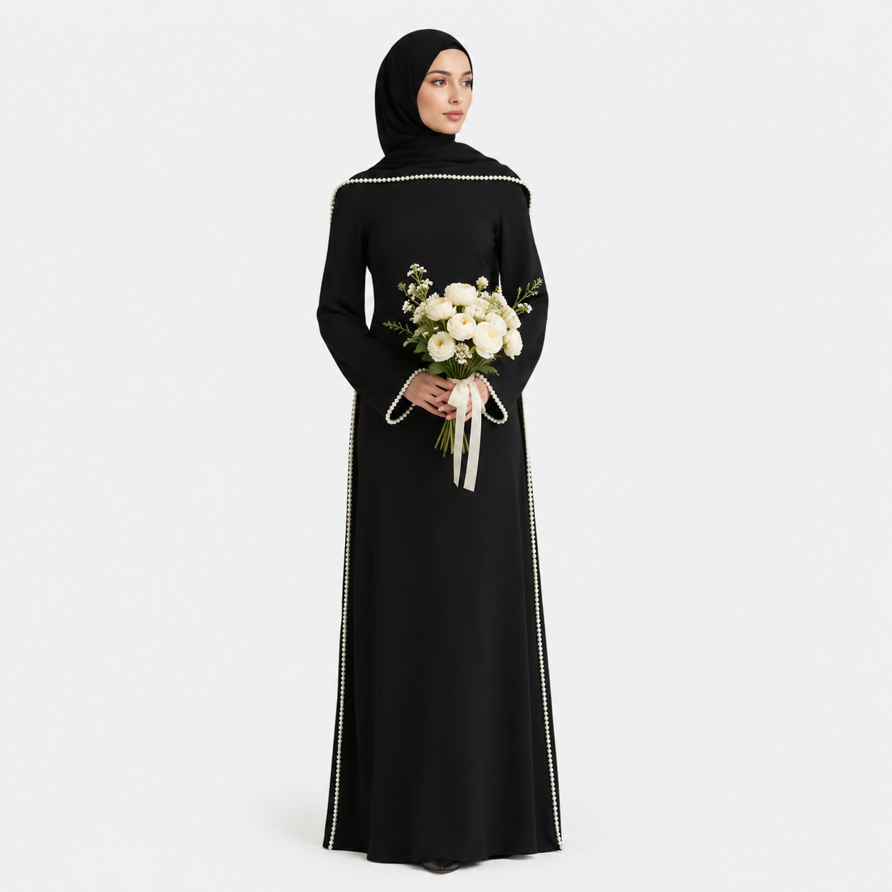 Woman in a black abaya holding a bouquet of flowers on a white background