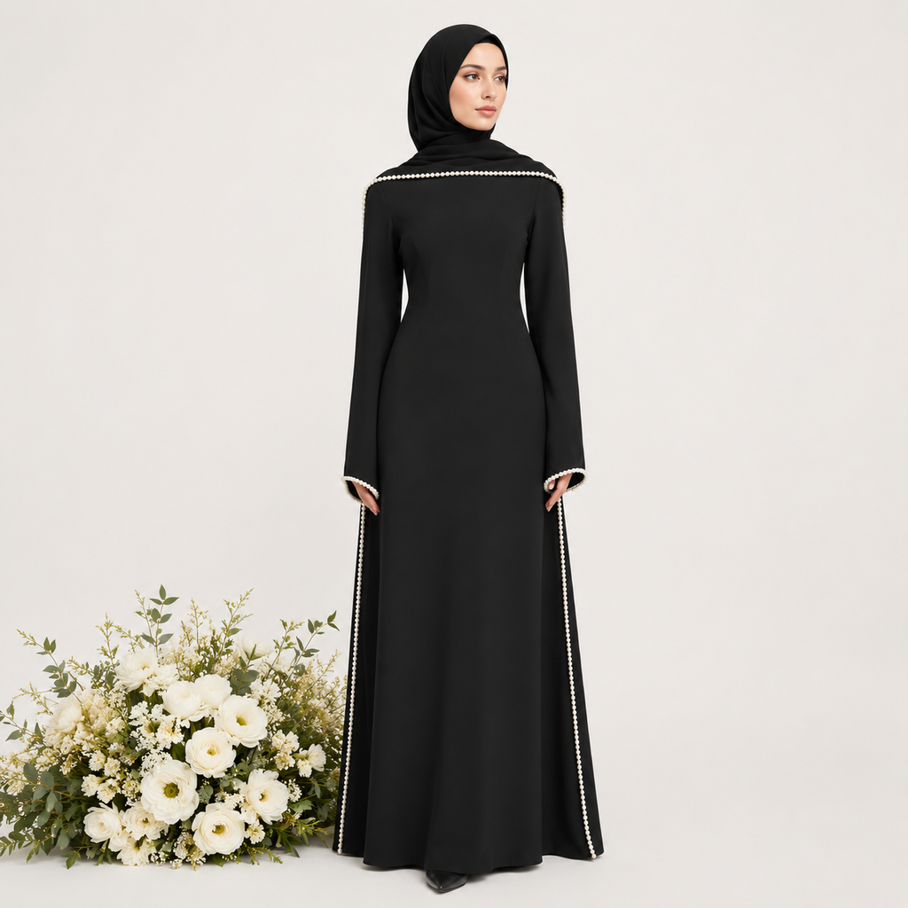 Woman wearing a black abaya with white trim on a light gray background with flowers.