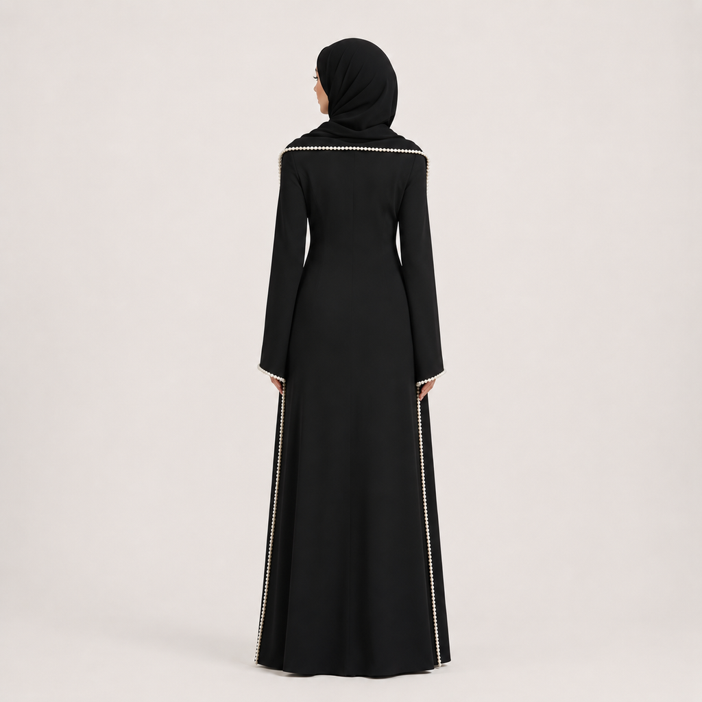 Black abaya with white embroidery on a light gray background