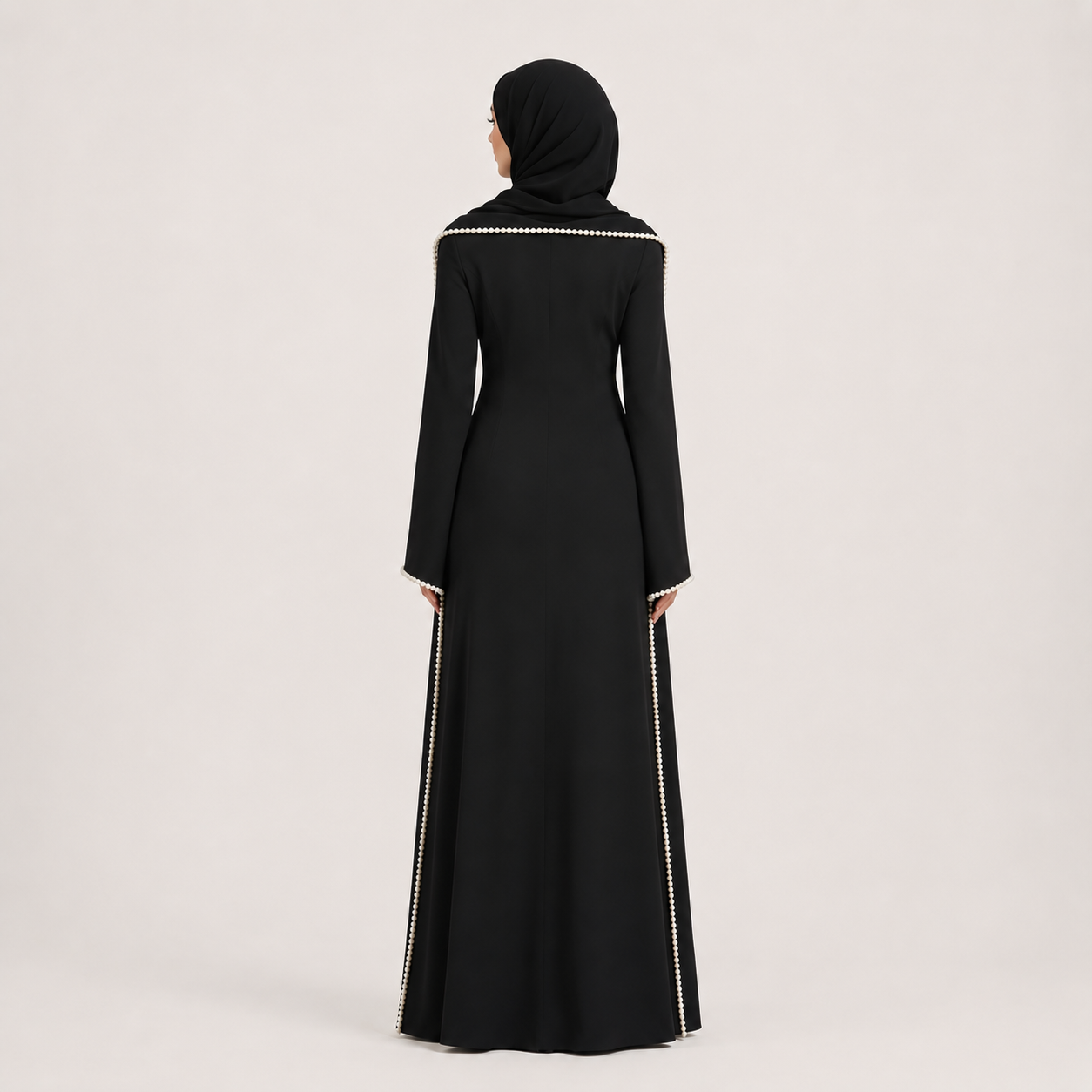Black abaya with white embroidery on a light gray background