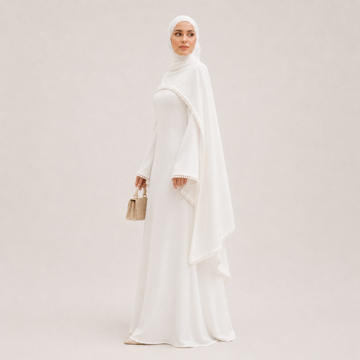 Woman wearing a white abaya and hijab against a light gray background
