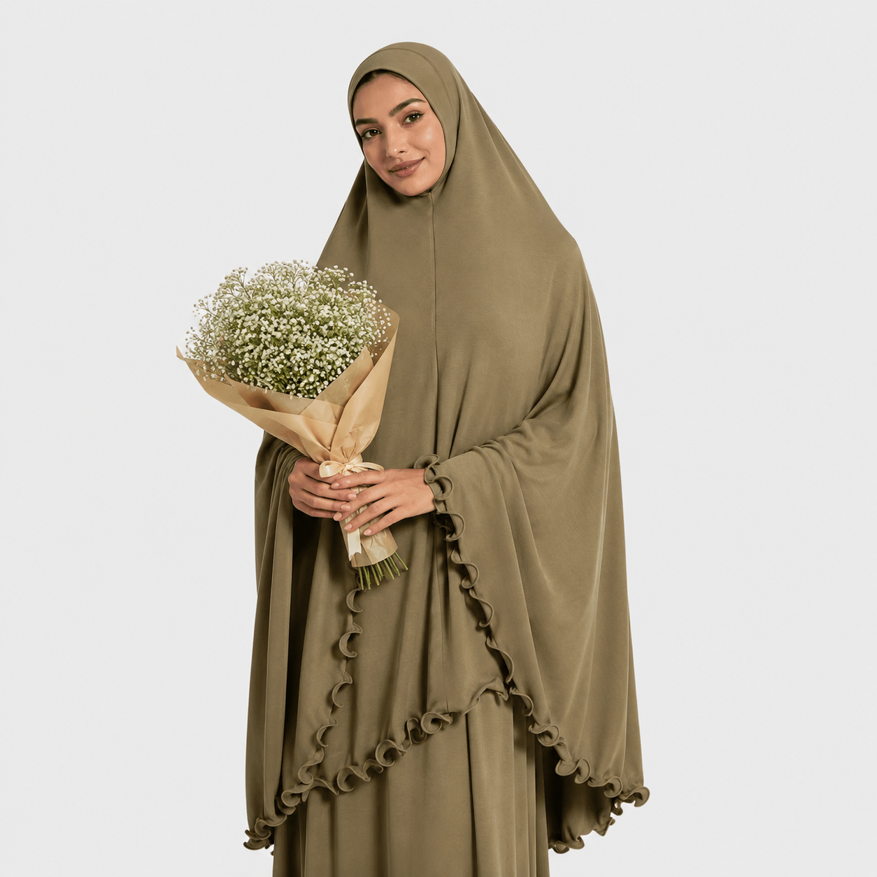 Woman wearing a green hijab and holding a bouquet of flowers on a white background