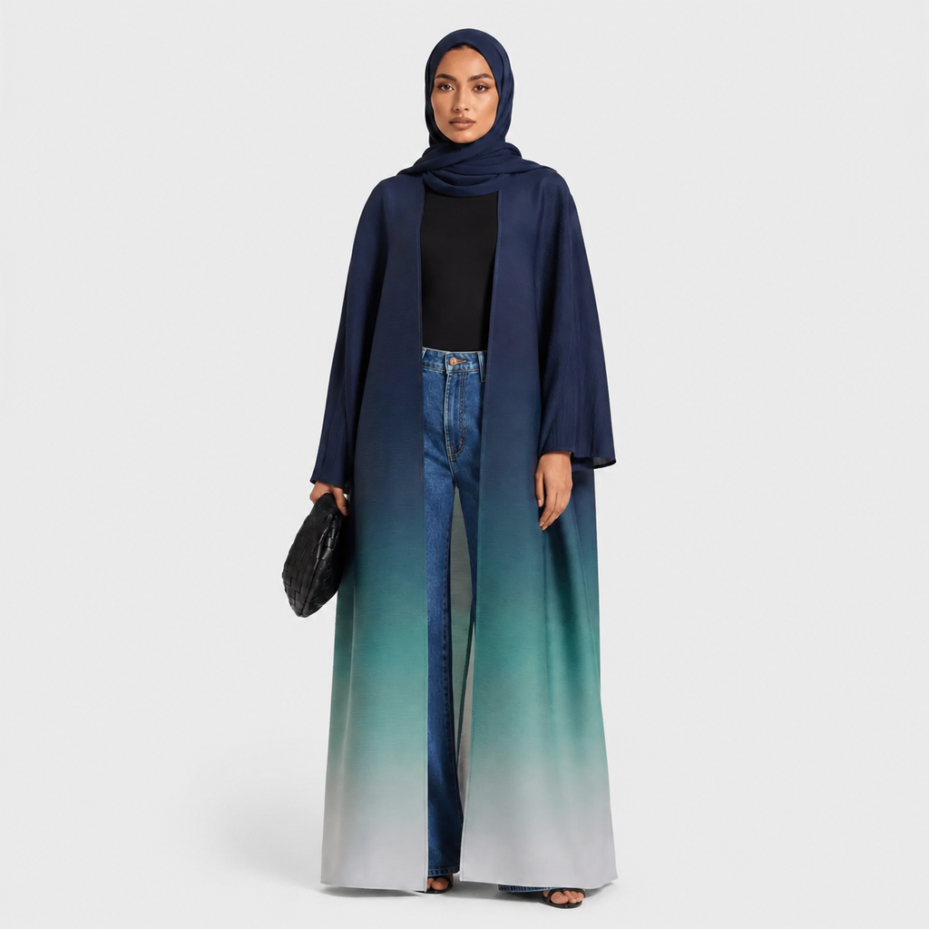 Woman wearing a long, gradient blue dress with a matching hijab on a white background