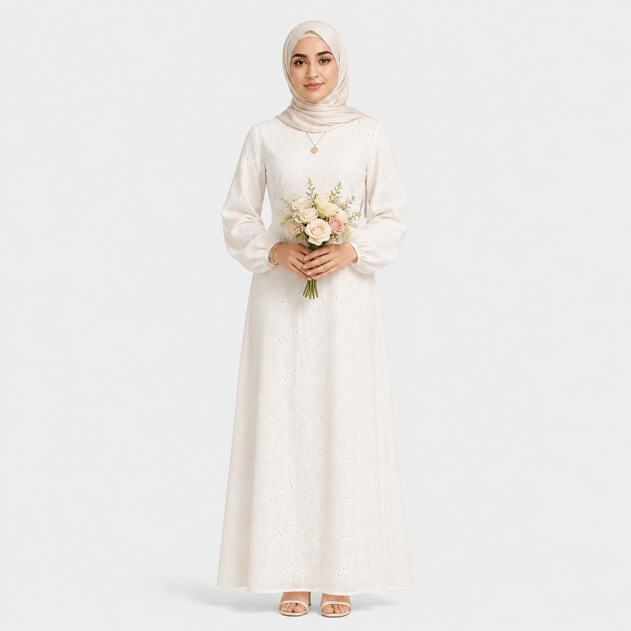 Woman in a white dress holding flowers on a plain background
