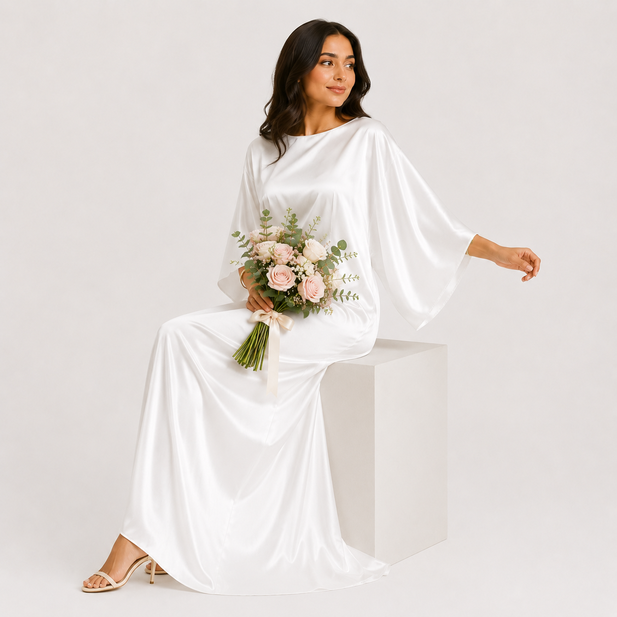 Woman in a white dress holding a bouquet of flowers and a beige handbag on a white background