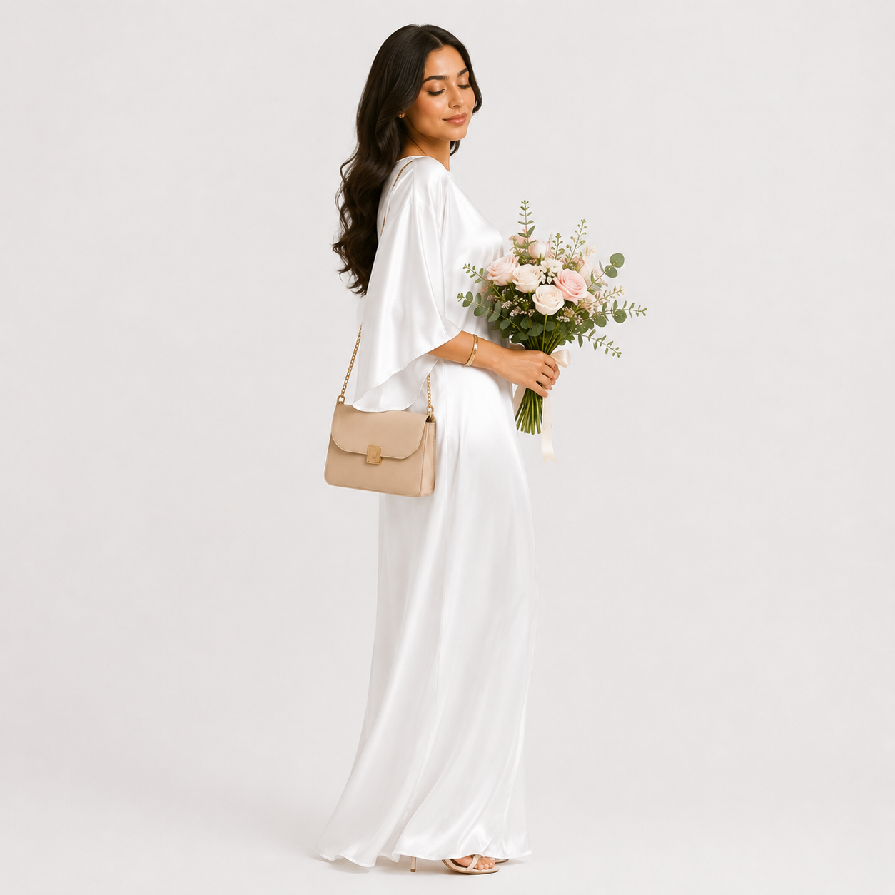 Woman in a white dress holding a bouquet of flowers and a beige handbag on a white background