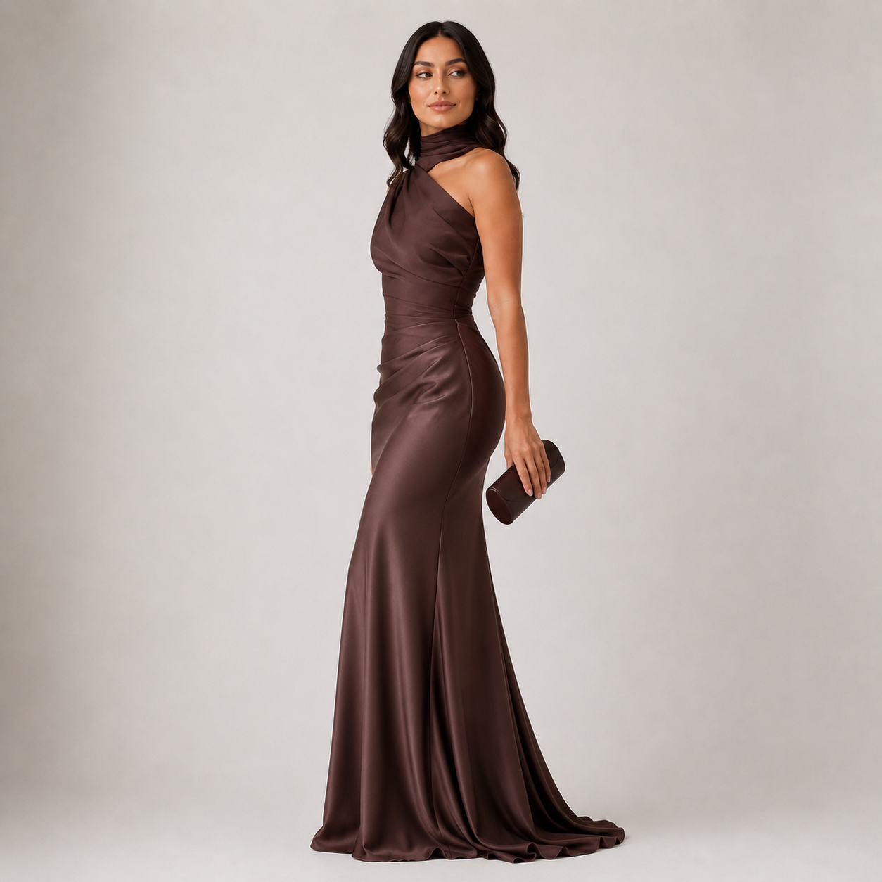 Woman wearing a brown evening gown against a plain background