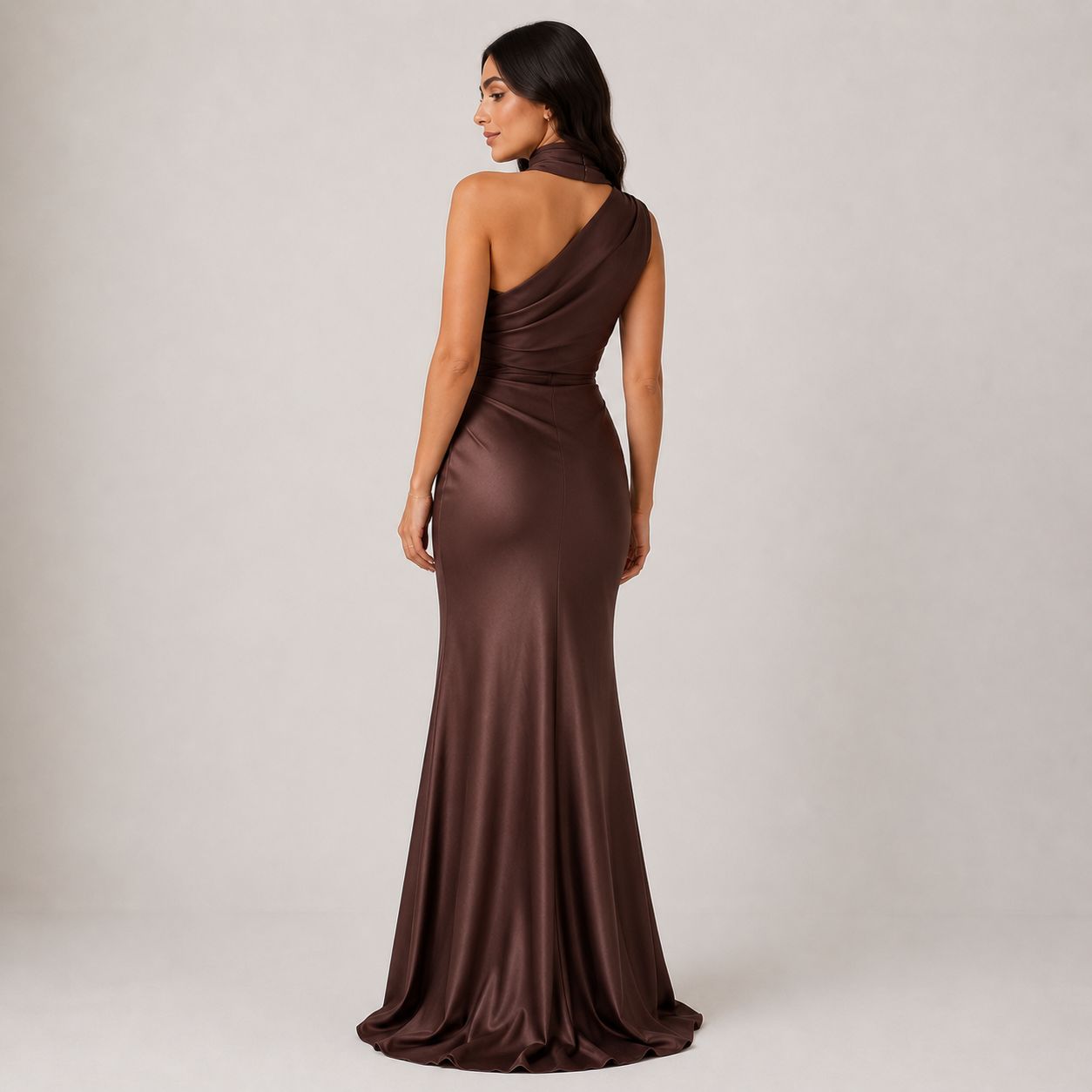 Woman wearing a brown evening gown on a plain background