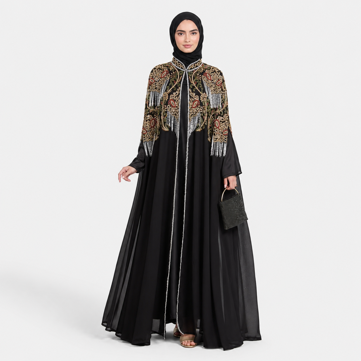 Woman wearing a black hijab and an intricately designed jacket with gold and red patterns on a white background