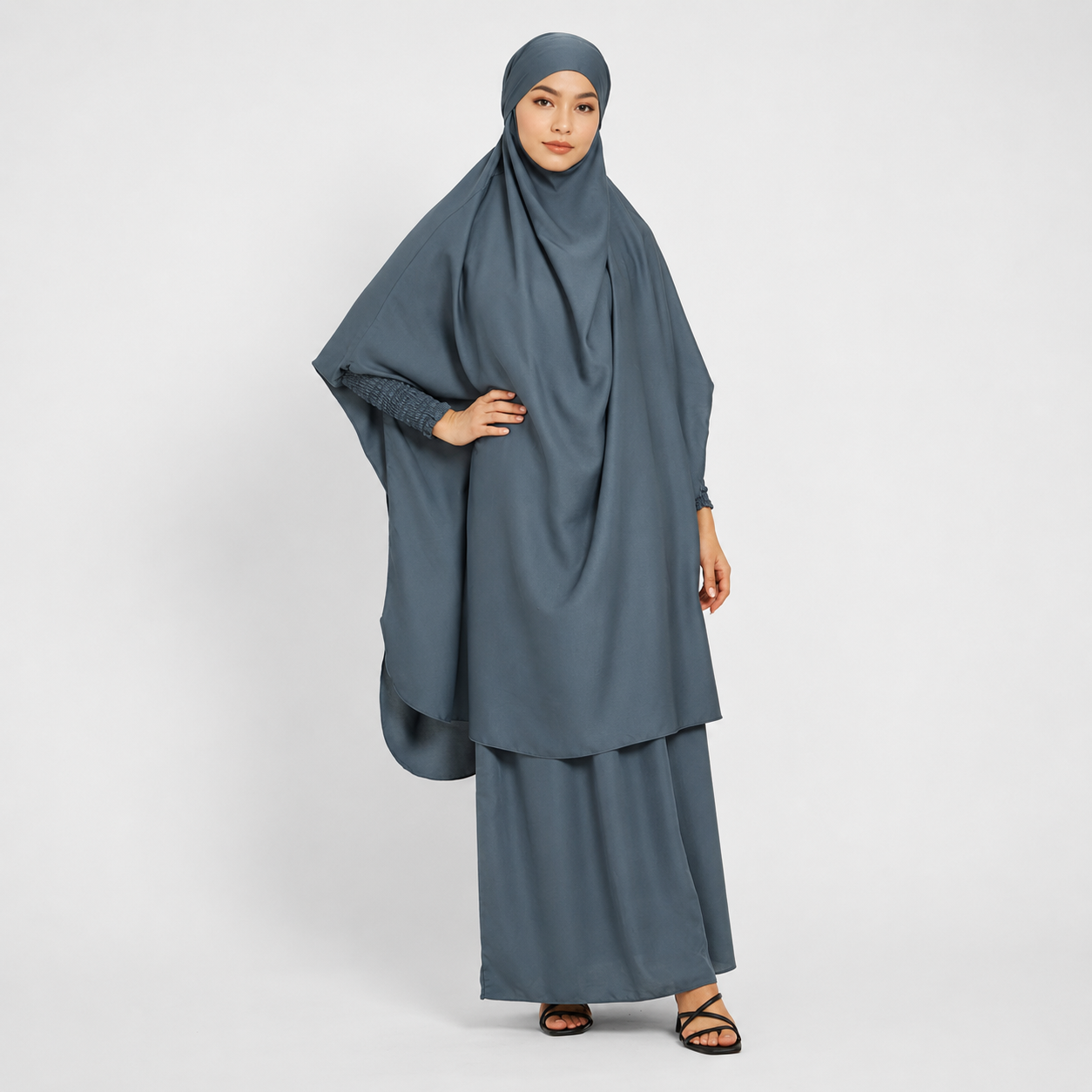 Woman wearing a gray traditional outfit on a white background