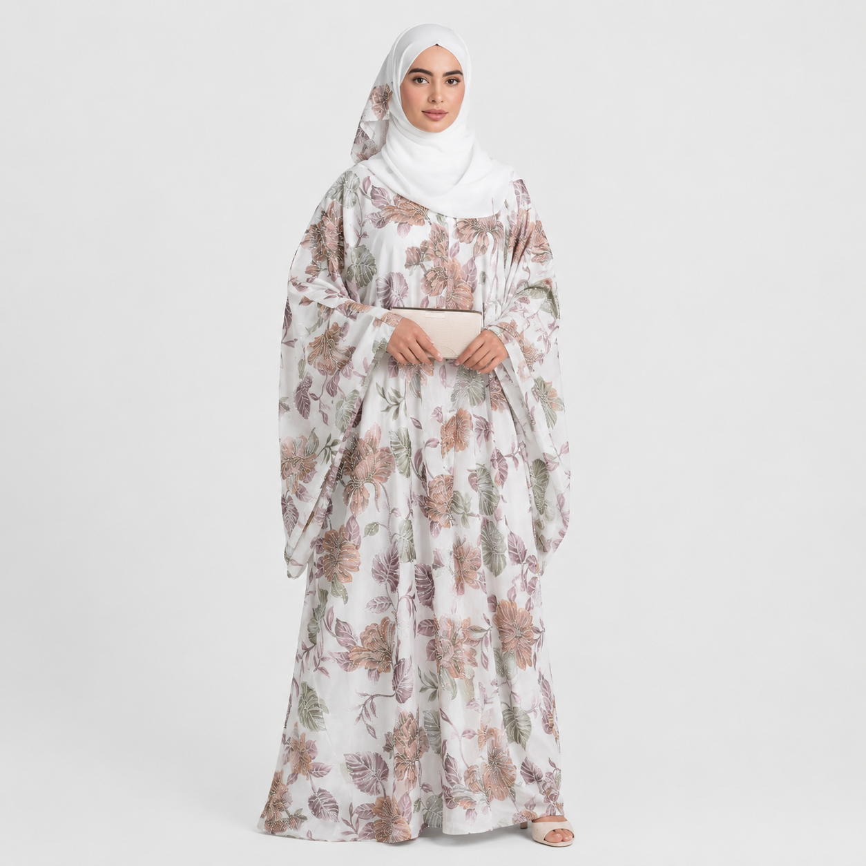 Woman wearing a floral abaya on a white background