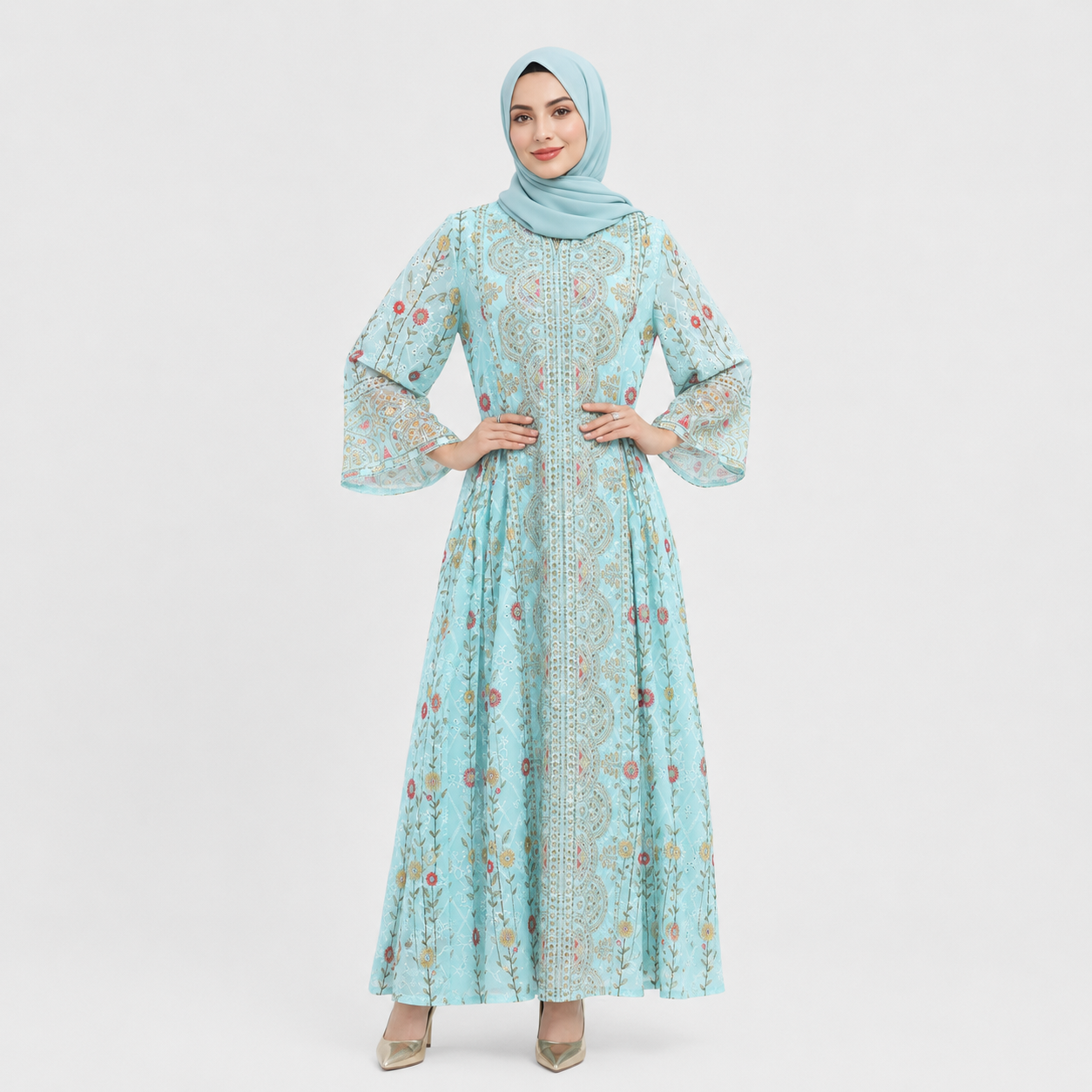 Woman wearing a light blue floral dress and hijab on a white background