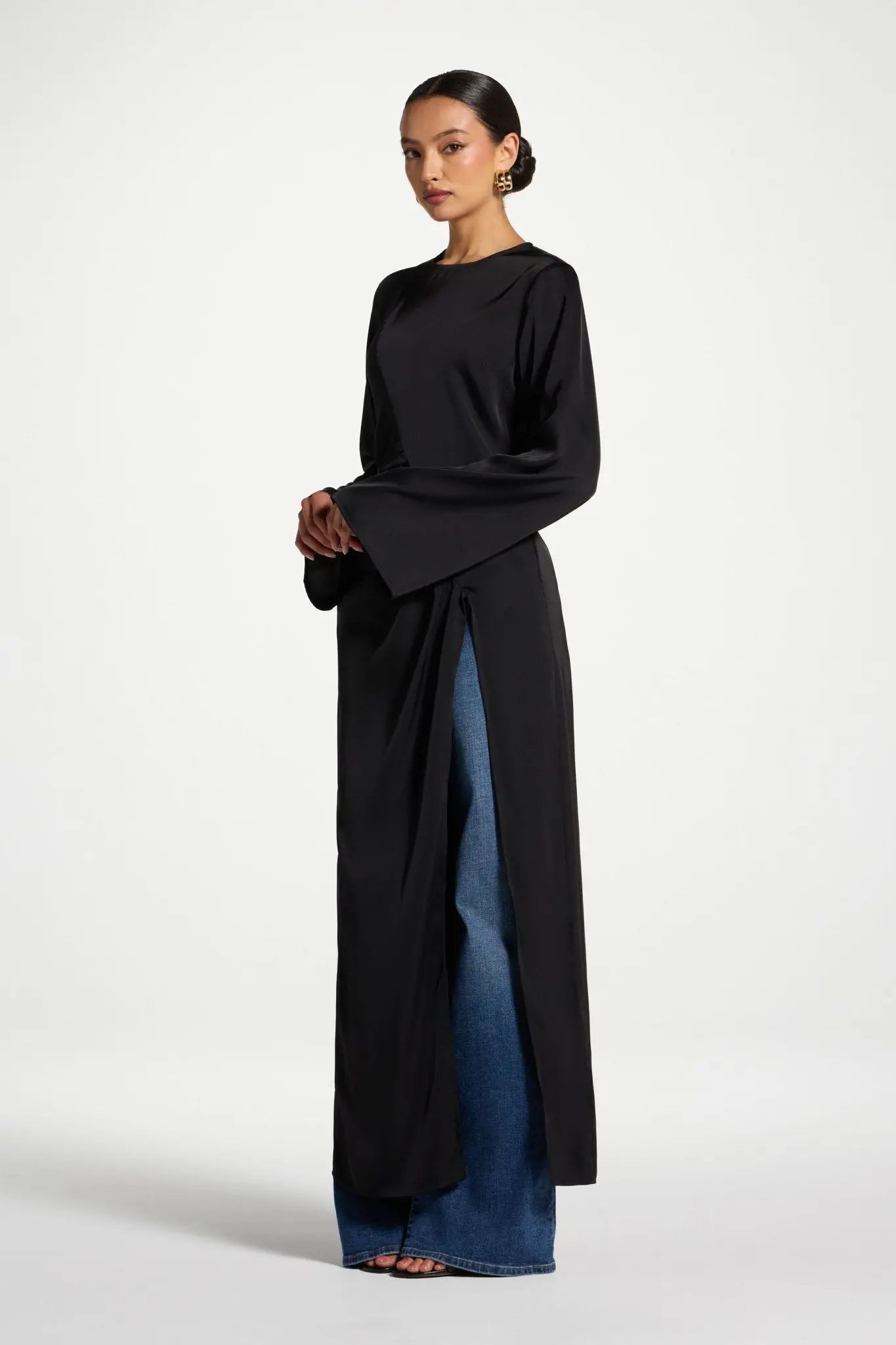 Woman wearing a black and blue dress on a white background