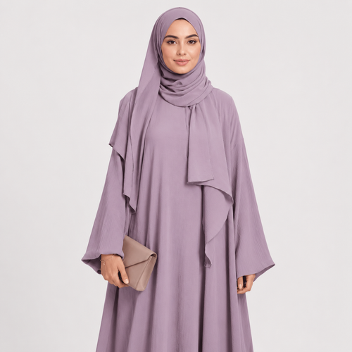 Woman wearing a light purple abaya with a matching hijab on a white background