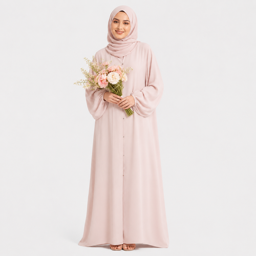 Woman in a long light pink dress holding flowers against a white background