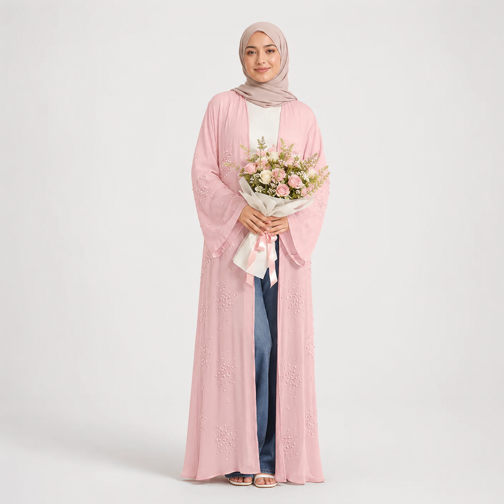 Woman wearing a pink abaya holding flowers on a white background
