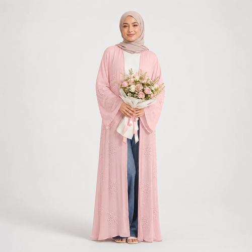 Woman wearing a pink abaya holding flowers on a white background