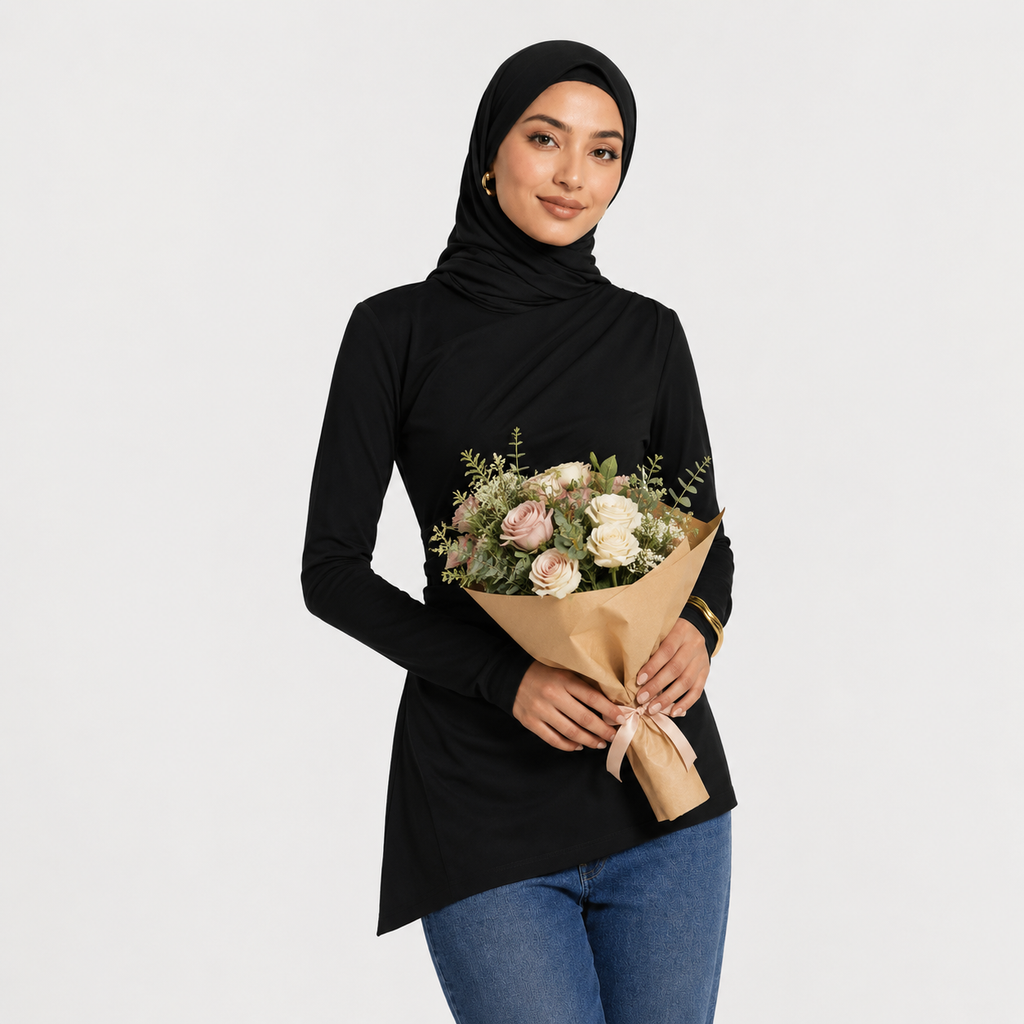 Woman holding a bouquet of flowers against a plain background
