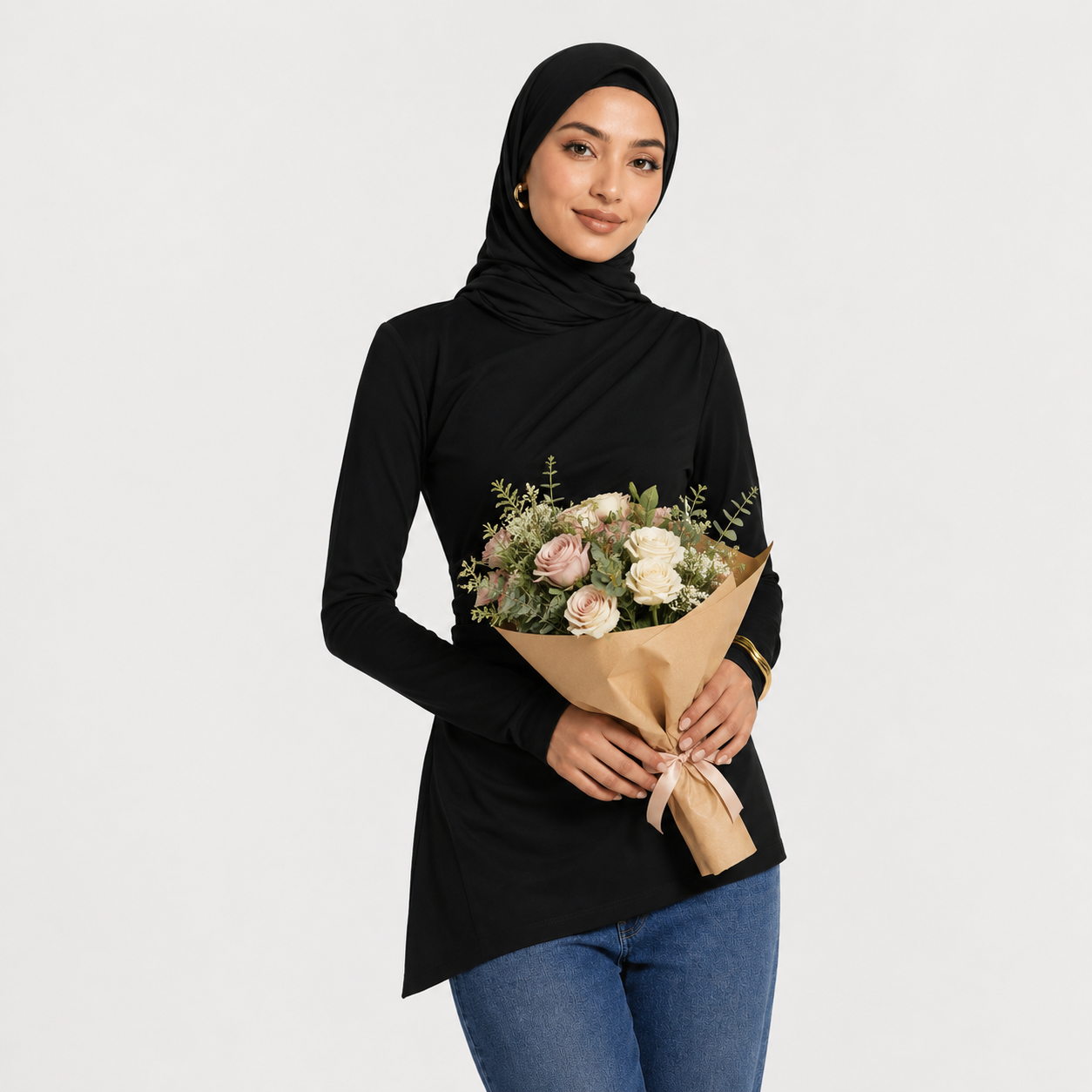 Woman holding a bouquet of flowers against a plain background