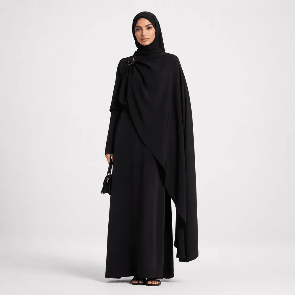 Woman wearing a black abaya on a white background