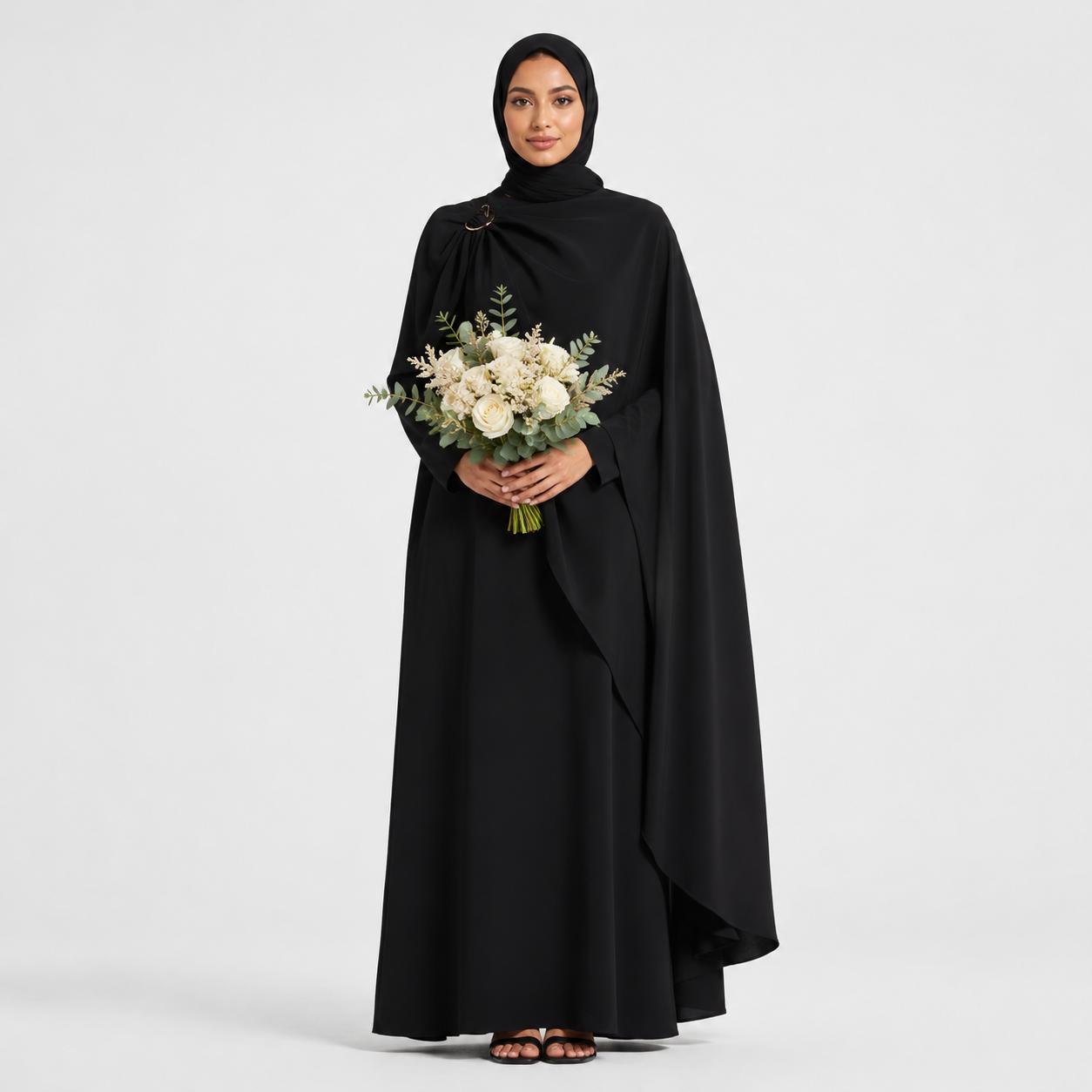 Woman in a black abaya holding a bouquet of flowers on a white background