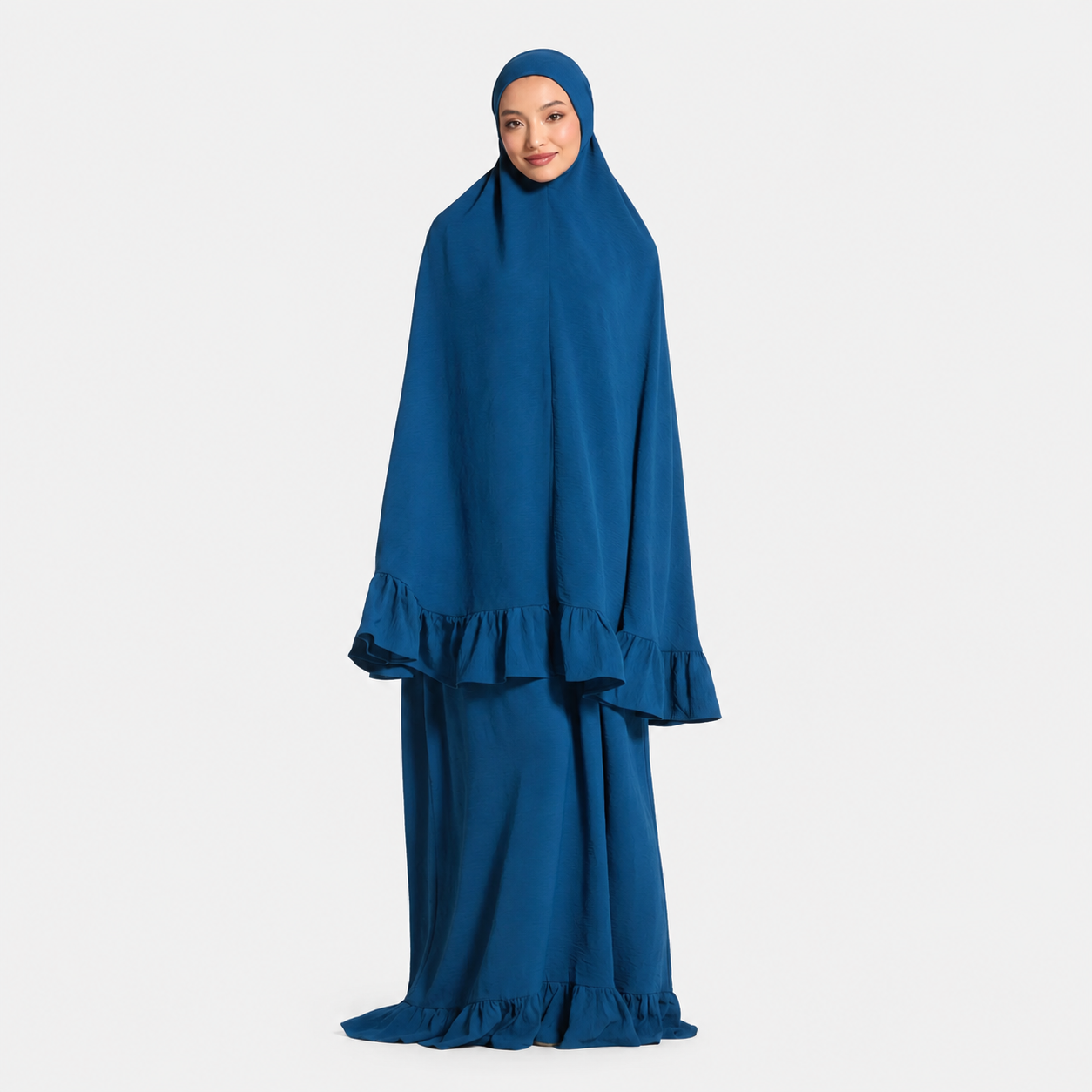 Woman wearing a blue abaya on a white background