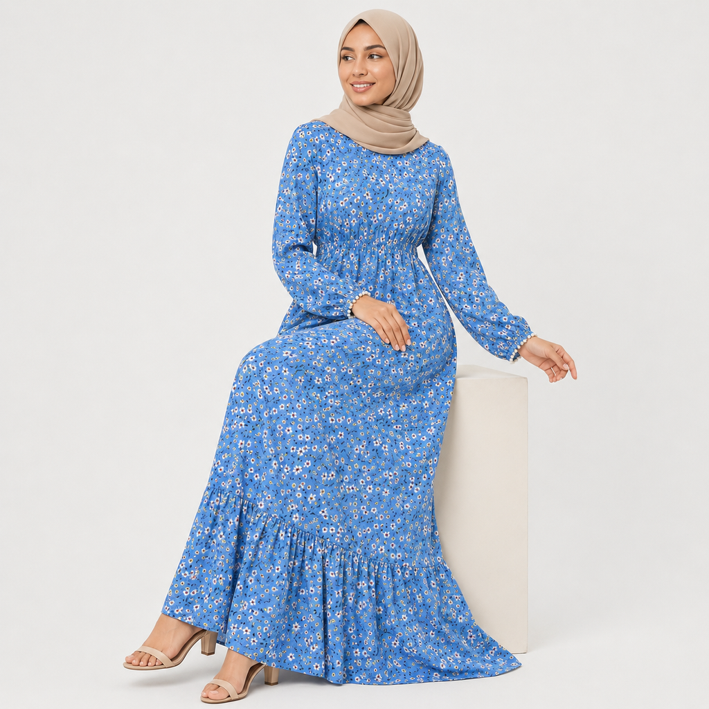Woman wearing a blue floral dress with a beige hijab on a white background