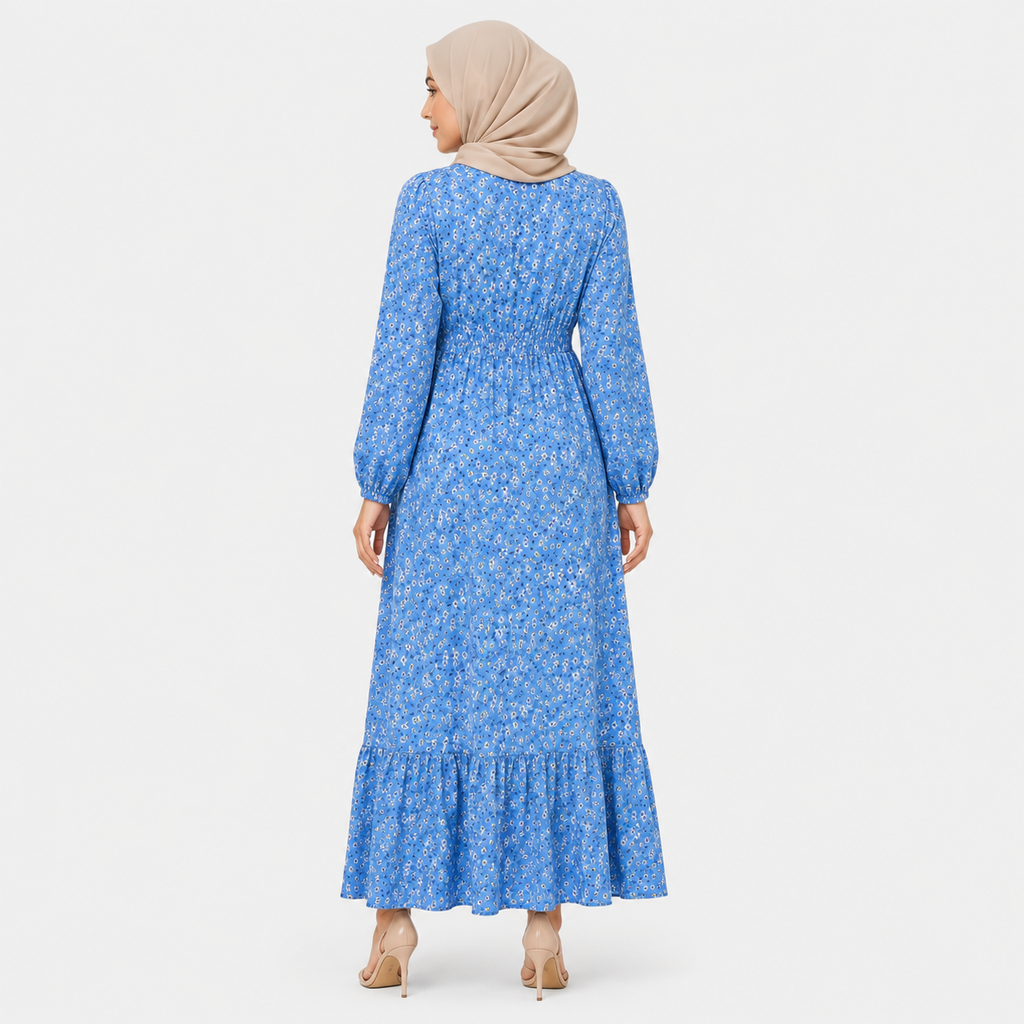 Woman wearing a blue floral dress with a beige hijab on a white background