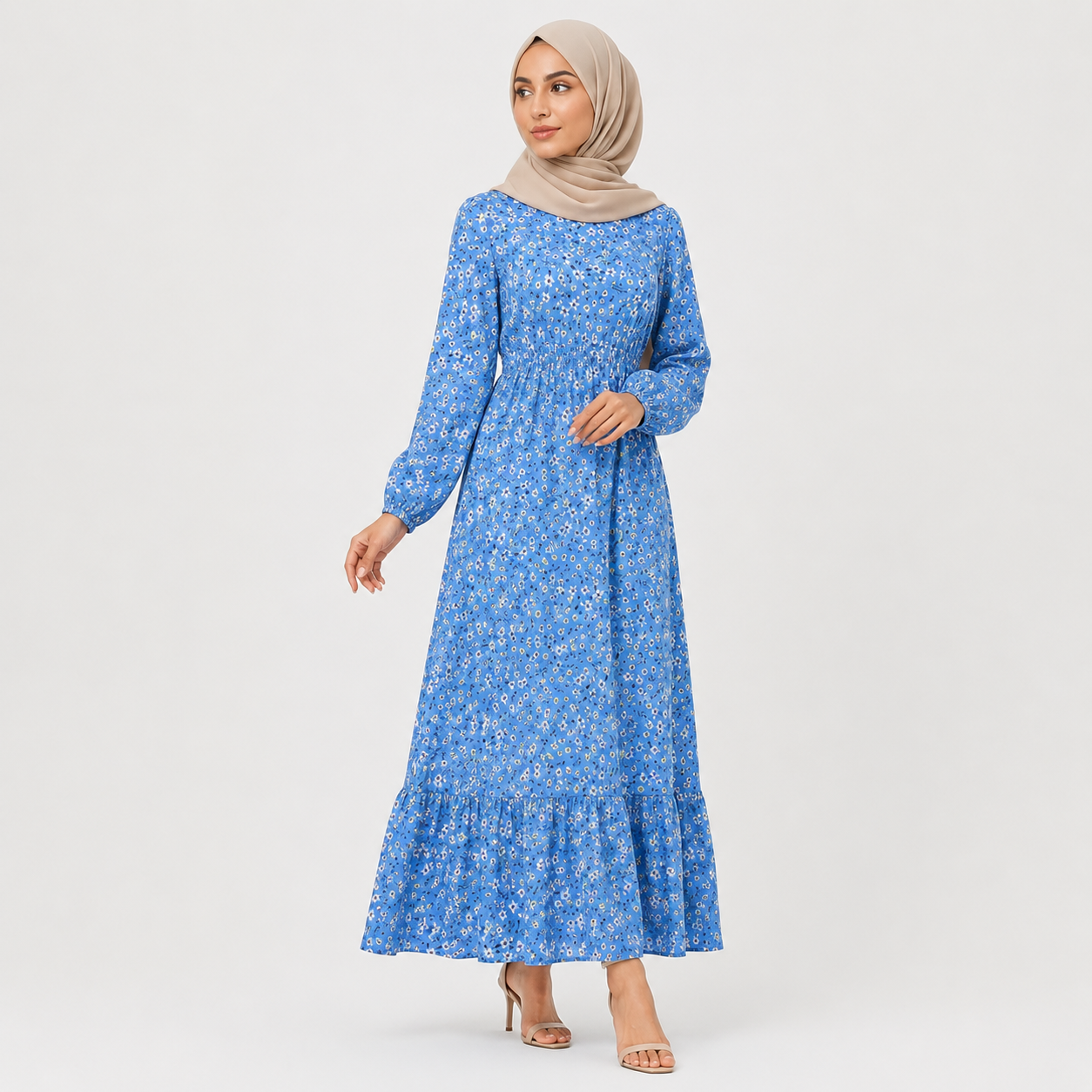 Woman wearing a blue floral dress with a plain background