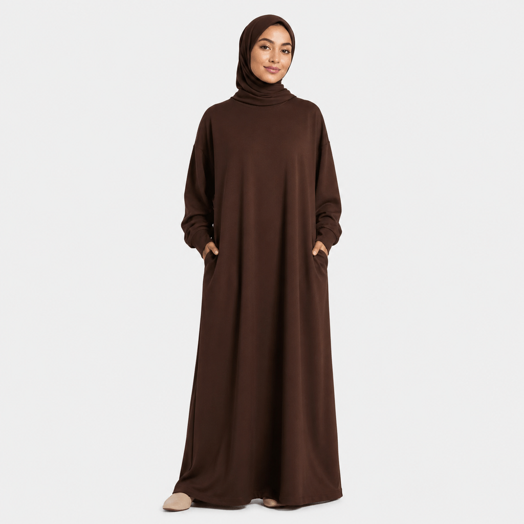 Woman wearing a brown abaya on a white background