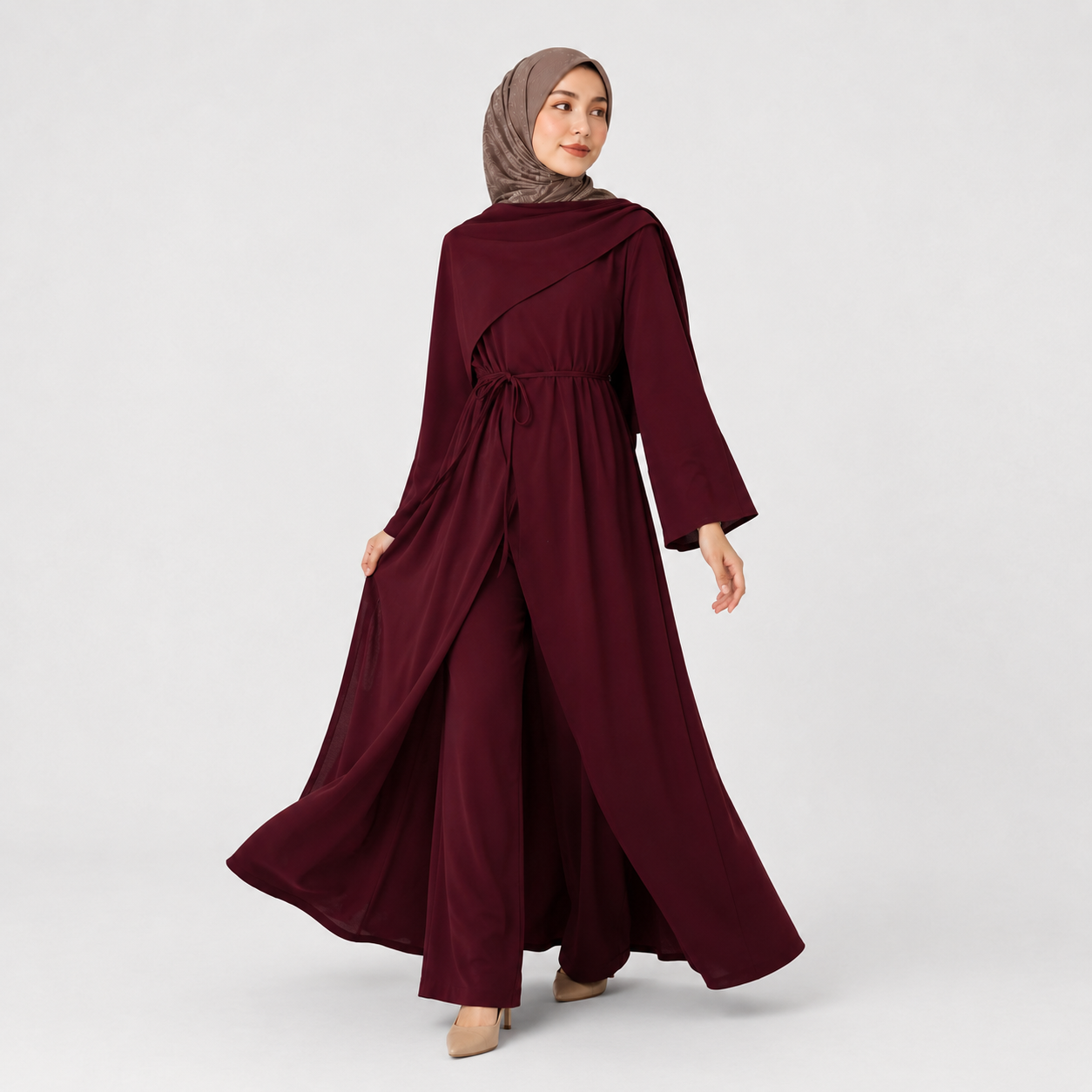 Woman wearing a burgundy dress with long sleeves on a white background