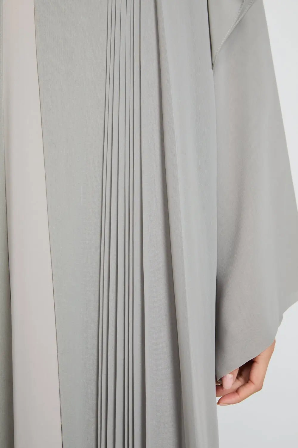 Close-up of a gray pleated garment with a blurred background