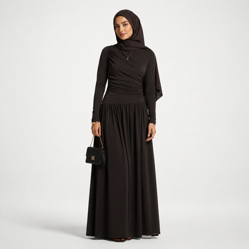 Woman wearing a black abaya and hijab on a white background
