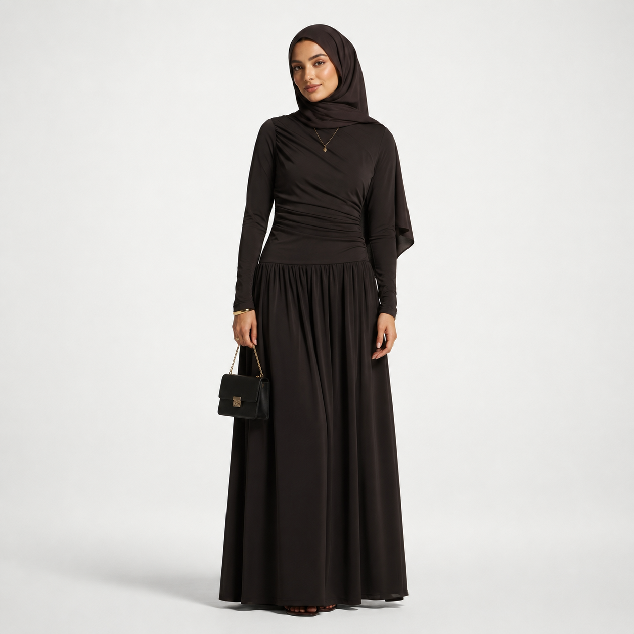 Woman wearing a black abaya and hijab on a white background