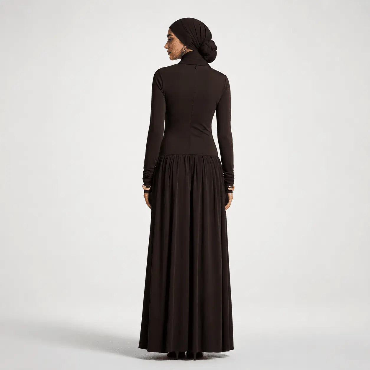 Woman wearing a long black dress on a white background