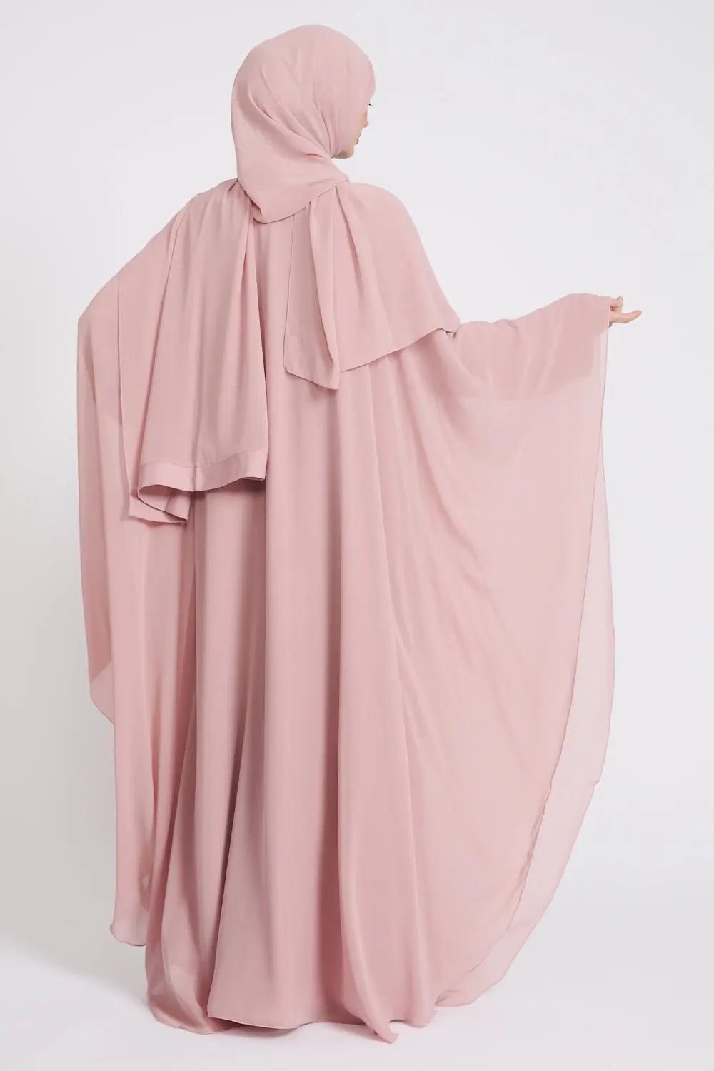 Pink abaya with matching hijab on a white background