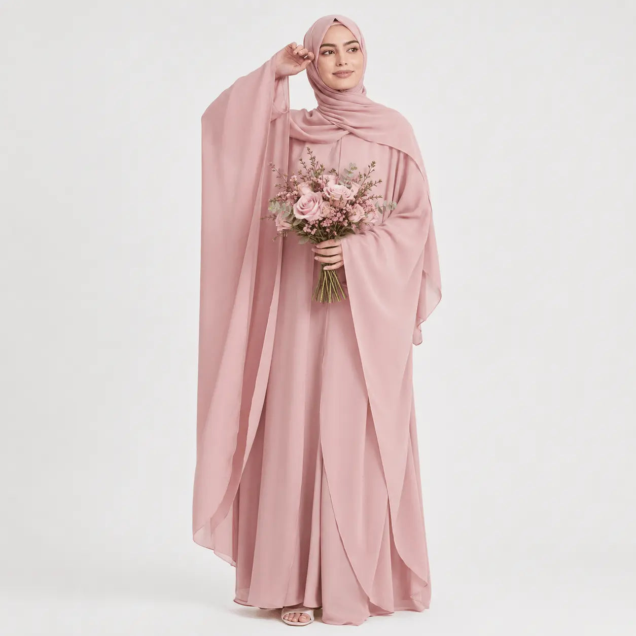 Woman in a pink abaya holding a bouquet of flowers on a white background