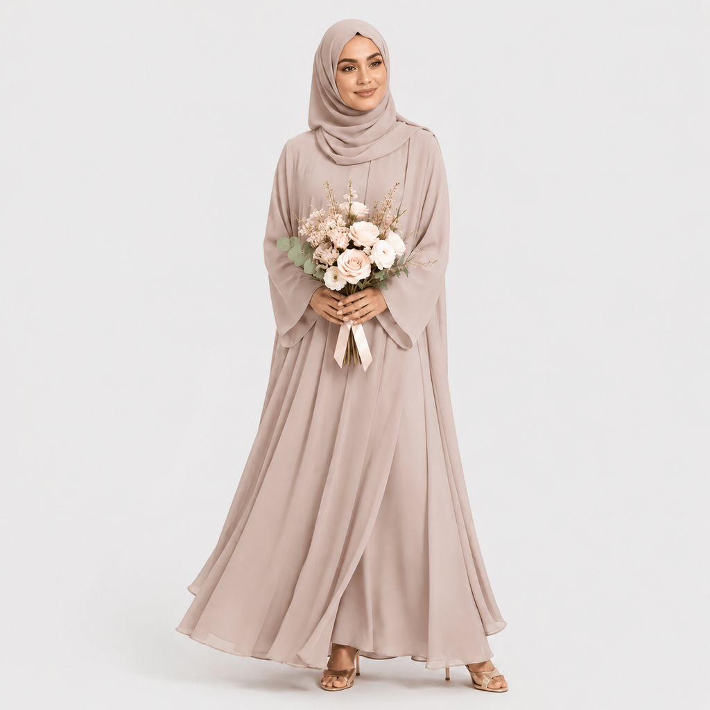 Woman in a long, light-colored dress holding flowers against a plain background