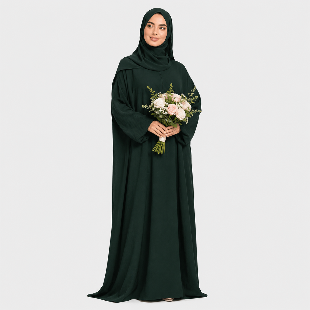 Woman in a dark green abaya holding a bouquet of flowers on a white background
