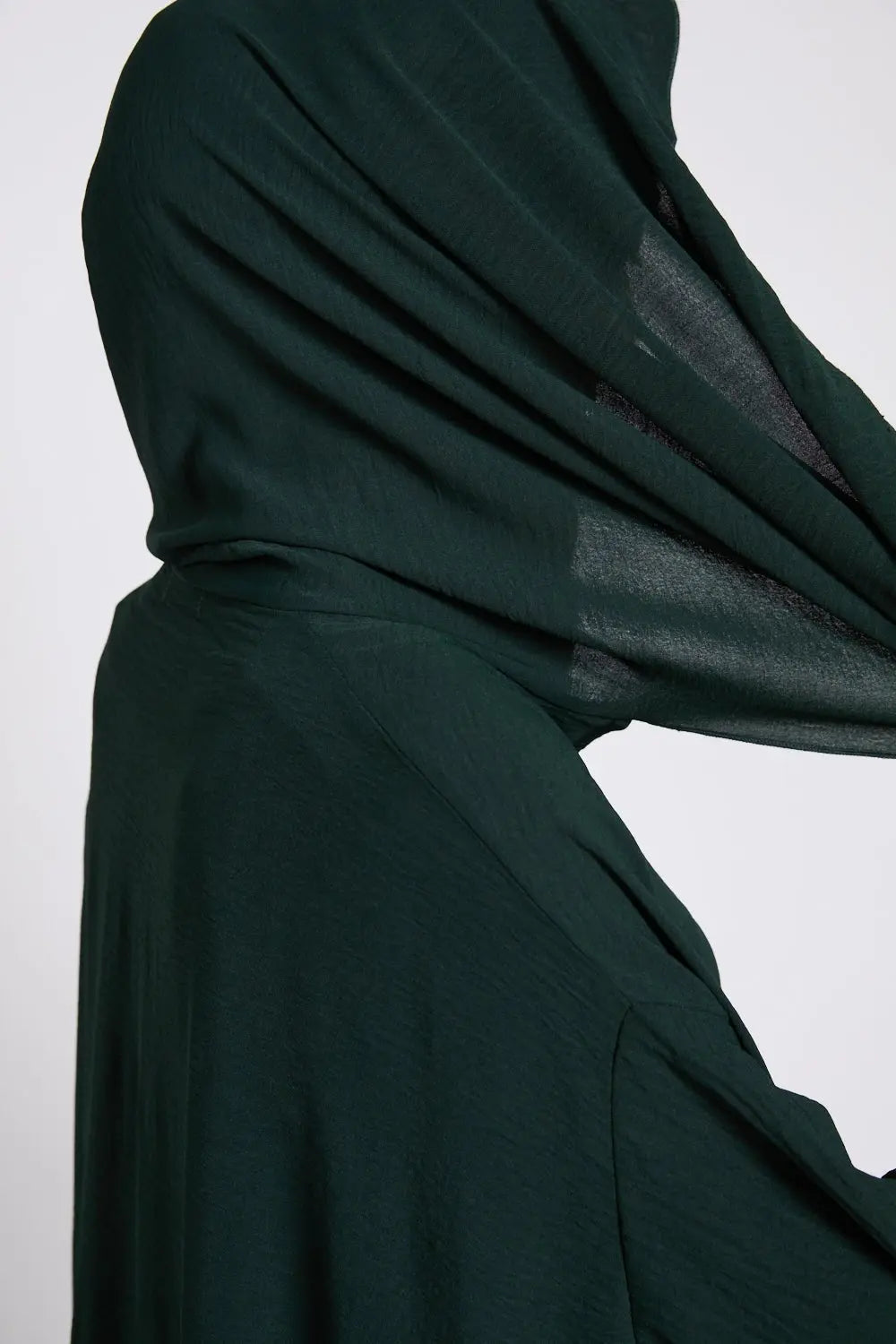 Dark green abaya on a white background