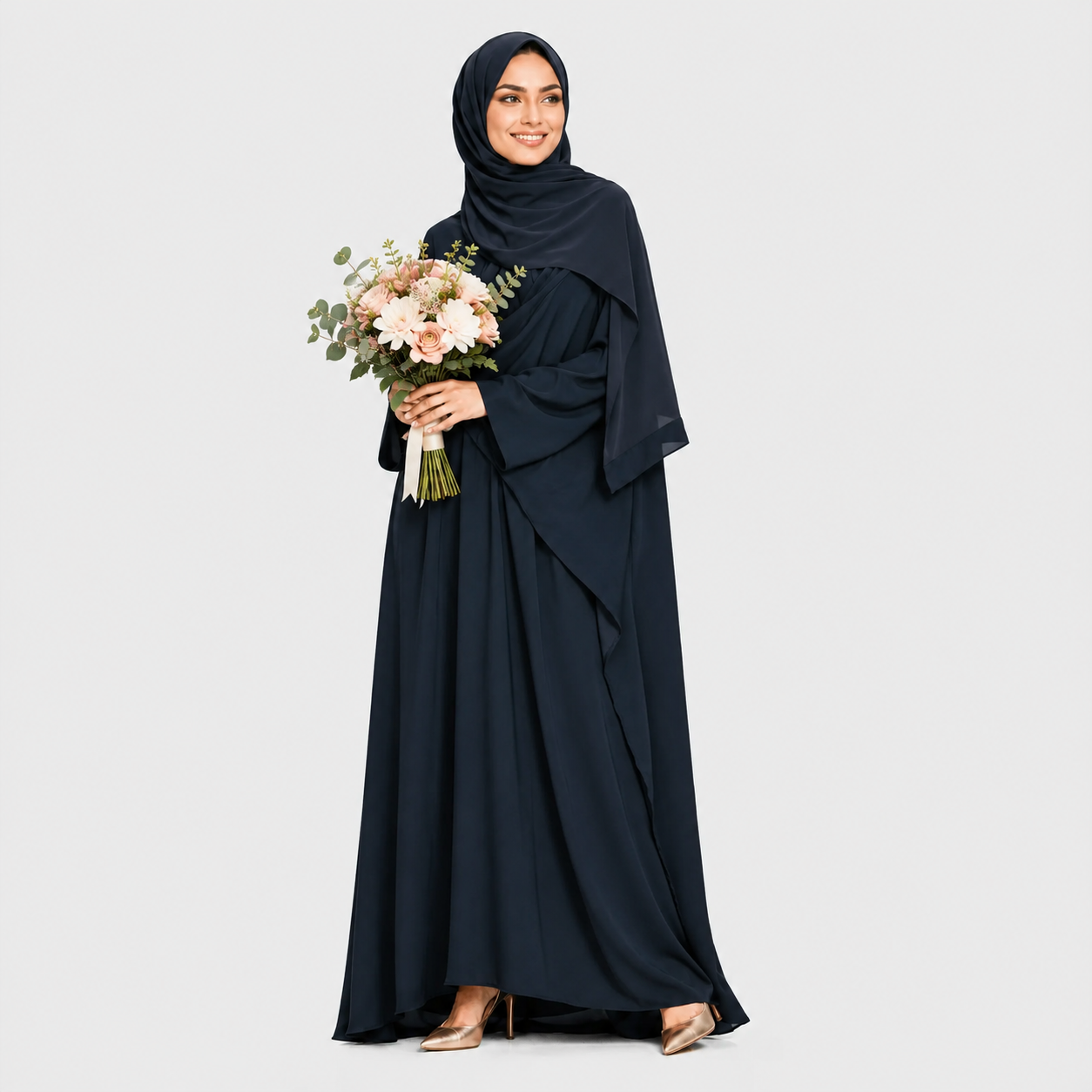 Woman in a long dark blue dress holding a bouquet of flowers on a light gray background